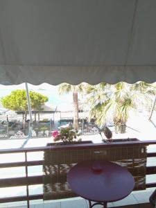 a table in a room with a view of a beach at Diamanto Rooms in Eretria