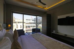 a hotel room with a bed and a large window at Hotel The IVY Grand With Free Secured Parking in New Delhi