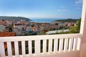 a white balcony with a view of a city at Studios Ravlić Marija in Makarska