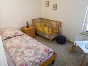 a bedroom with a crib with a stuffed animal in it at Ferienwohnung Alte Schmiede in Niepars