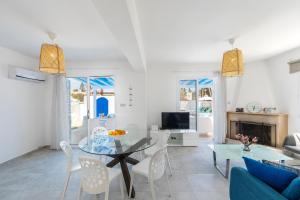 a living room with a glass table and chairs at Fig Tree Bay Villa 4 in Protaras