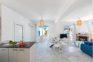 a kitchen and living room with a table and chairs at Fig Tree Bay Villa 4 in Protaras