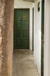 a hallway with a green door in a building at Big Tree Boutique Hotel in Ko Tao