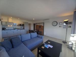 a living room with a blue couch and a table at Manuel Apartment - Belch1952 in Lagos