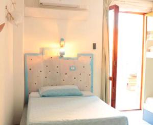 a bedroom with a bed and a dresser at Hostel Sardinia in Quartu SantʼElena