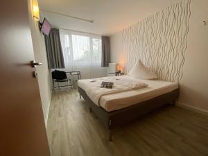 Tempat tidur dalam kamar di Pro Messe Hotel Hannover
