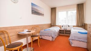 a hospital room with two beds and a sink at Pomorze Ustka in Ustka