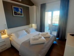 a bedroom with a bed with two towels on it at Deluxe Jelsa in Jelsa