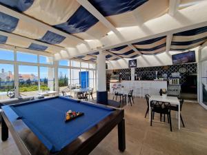 a living room with a pool table in it at Windmill Hill in Albufeira