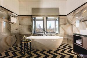 a bathroom with a large tub and a window at Grand Poet Hotel and SPA by Semarah in Riga