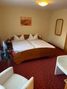 En eller flere senge i et værelse på Fischanger Resort