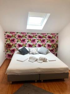 a bedroom with a bed with a flower wall at OLD COURT KOPER in Koper