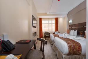 Ein Bett oder Betten in einem Zimmer der Unterkunft The Kyaka Hotel