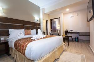 Ein Bett oder Betten in einem Zimmer der Unterkunft The Kyaka Hotel