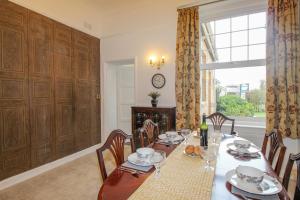a dining room with a table and chairs and a window at Weymouth Bay Apartment A in Weymouth