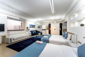 a bedroom with two beds and a living room at Dubai JBR Amaz Penthouse front sea 5 plus 1 Bdr private Climatized pool in Dubai