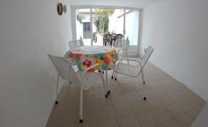 a table and chairs in a room with a table at Casa Rural Guadiela II in San Pedro Palmiches