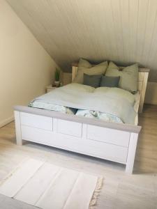 a bed with a white frame in a room at Ferienwohnung Brehm in Bad Staffelstein