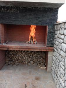 a brick oven with a fire in it at Kuća za odmor MARIA in Vodice