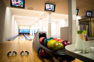 a bowling alley with pins and bowling balls on the lanes at Amenity Hotel & Resort Lipno in Lipno nad Vltavou