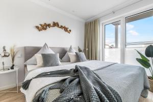 a bedroom with a large bed with a window at Spinnaker in Olpenitz