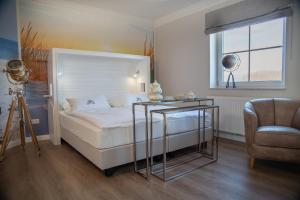 Postel nebo postele na pokoji v ubytování HOTEL DÜNENLÄUFER Carolinensiel