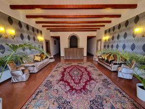 a living room with couches and a large rug at Villa Godenano - Country Chianti Villa in Castellina in Chianti