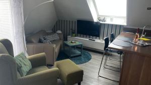 a living room with a couch and a tv at Haus-Encore-Wohnung-2 in Büsum