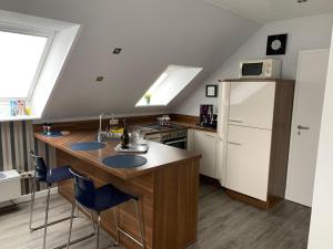 a kitchen with a sink and a refrigerator at Haus-Encore-Wohnung-2 in Büsum