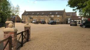 a large building with cars parked in front of it at Holywell Grange Farm in Whitley Bay +15 photos