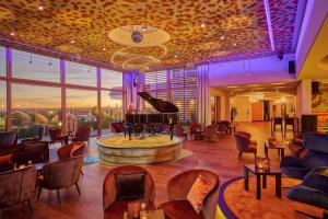 a hotel lobby with a piano in a room at Der Birkenhof Spa & Genuss Resort in Hofenstetten