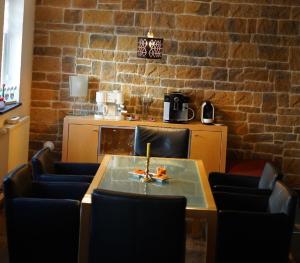 a table and chairs in a room with a brick wall at Wandas Domizil mit Whirlpool in Untermerzbach