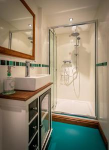 a bathroom with a sink and a shower at Woodbottom Farm - A Splendid Yorkshire Getaway in Todmorden