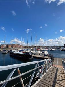 a dock with boats docked in a marina at Djinn Palace by Serviced Living Liverpool in Liverpool