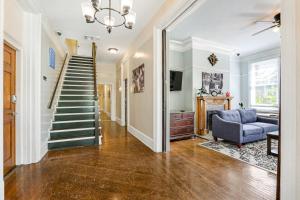 a living room with a staircase and a blue couch at Newly-renovated Comfortable Studios Near All NOLA Hot Spots in New Orleans