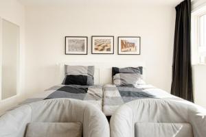 Ένα ή περισσότερα κρεβάτια σε δωμάτιο στο Julianadorp Zuhause am Meer für 6 Personen mit 4 Schlafzimmern