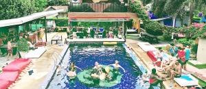 a group of people in a swimming pool at WET! a Pool Party Hostel by Wild & Wandering in Haad Rin