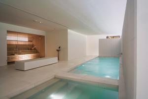 a swimming pool in the middle of a room at La Galiana Golf Resort - Adults Only in Barraca de Aguas Vivas