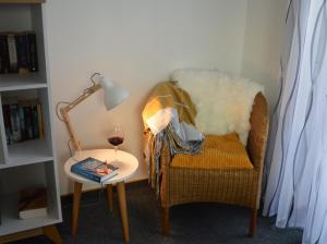 a chair and a table with a glass of wine at Ferienwohnung Alb-Traum in Erkenbrechtsweiler