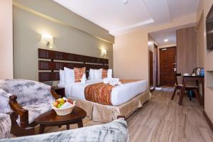 Ein Bett oder Betten in einem Zimmer der Unterkunft The Kyaka Hotel