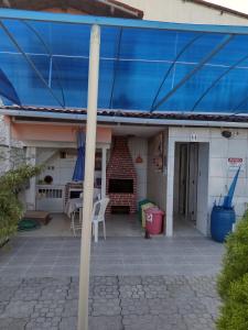 a blue covering on a house with a patio at Casa em Ponta De Pedras- Encanto do Litoral! in Recife