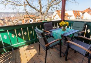 um pátio com uma mesa e cadeiras numa varanda em Ferienwohnung Jenzigblick em Jena