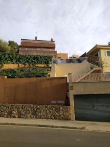 a building next to a street with a garage at Villa Flamante in Tarragona