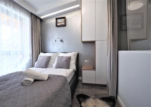 Posteľ alebo postele v izbe v ubytovaní VIP Apartamenty Modrzejewska Residence