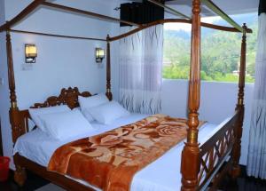 A bed or beds in a room at Wathsala Inn