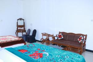 A bed or beds in a room at Wathsala Inn