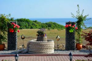 a large tire with potted plants on top of it at къщички Поляните in Sinemorets