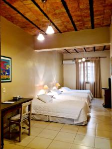 a bedroom with a large bed and a desk at Asuncion Palace in Asunción +61 photos