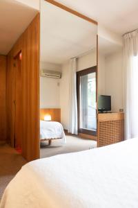 a hotel room with a bed and a television at Hotel Due Mori in Cittadella +37 photos