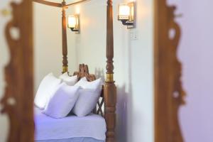 A bed or beds in a room at Wathsala Inn